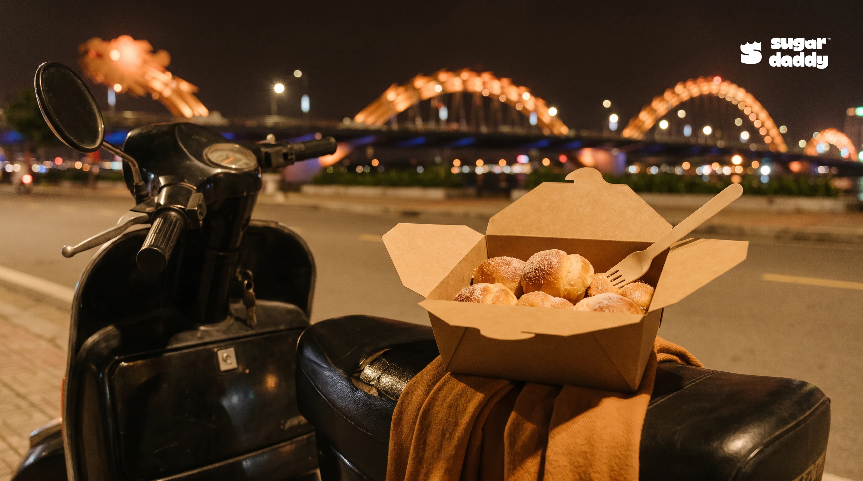 Warm brioche, an enticing best dessert near Dragon Bridge, sits on a scooter at night.