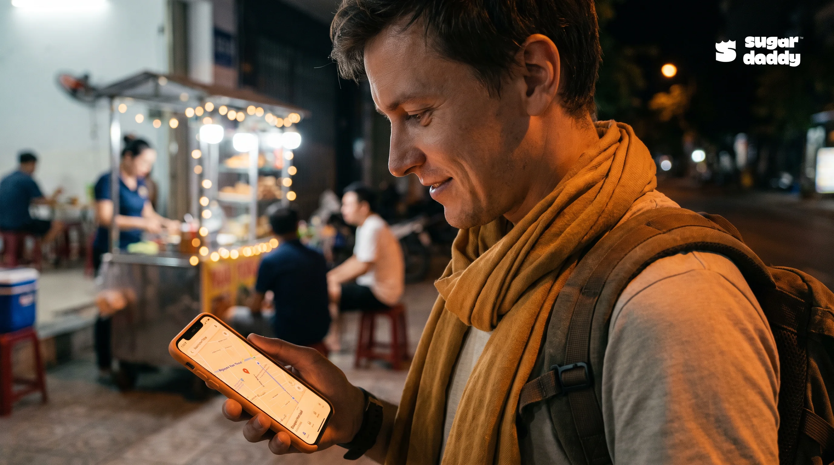 A person uses a smartphone to find late night food An Thuong options on a street.