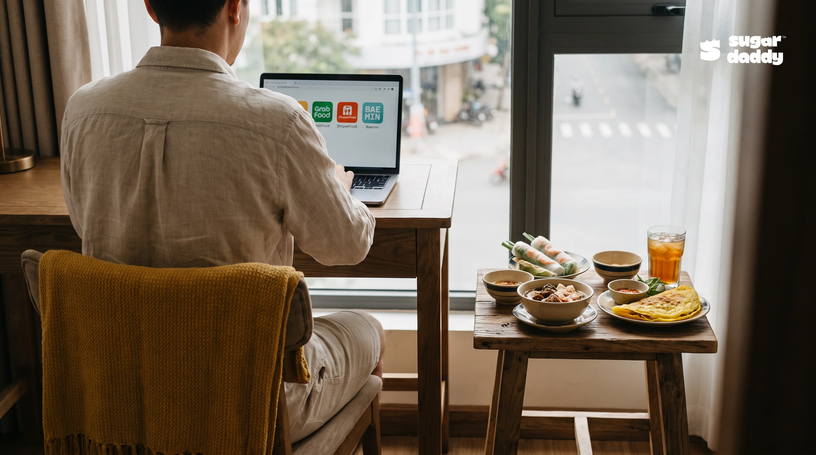 Tourist browsing food delivery options on a laptop for local meals in Da Nang.