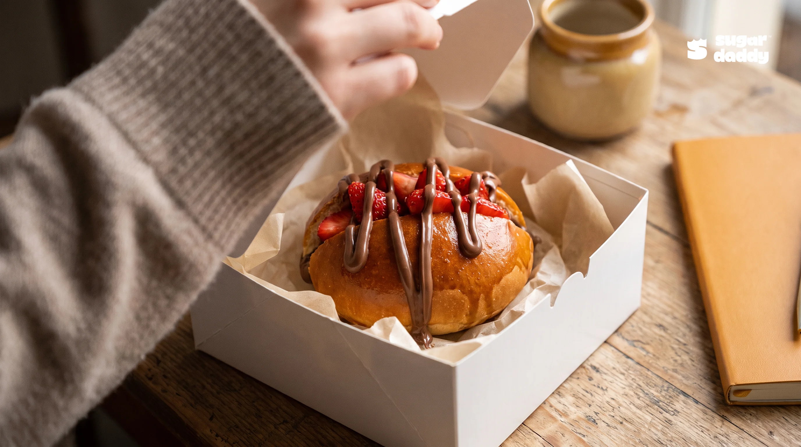Close-up of Sugar Daddy's Red Temptation brioche, one of the best warm desserts, in a delivery box.